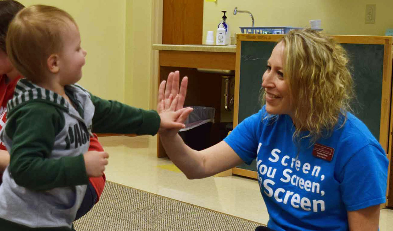 screener high-fiving child